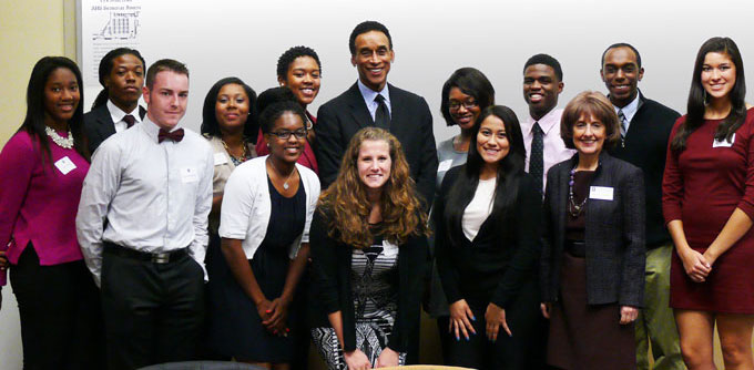 group shot of 12 students with Mannie Jackson and Dean Gallagher